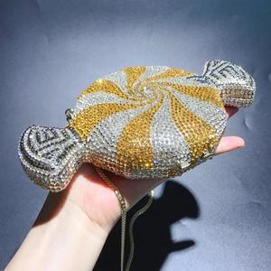 Detail of candy-shaped luxury evening bag with sparkling gold and silver rhinestones