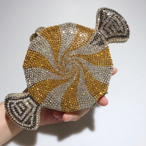 Macro view of candy shaped evening clutch with gold and black sparkling rhinestones
