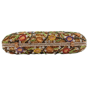 Detail of hollow out gold evening clutch bag with colorful rhinestones and jewels