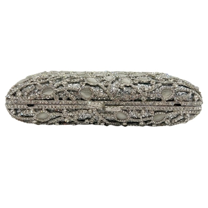 Macro shot of silver evening clutch with rhinestones and white cat eye stones decor