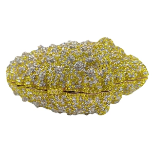 Close-up of luxury conch shell clutch with sparkling yellow and white crystal rhinestones