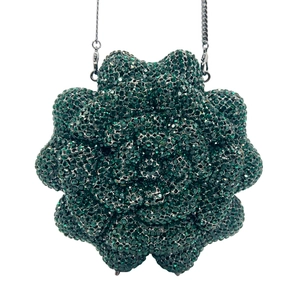 Detailed macro view of dark green flower-shaped clutch bag with sparkling crystal rhinestones