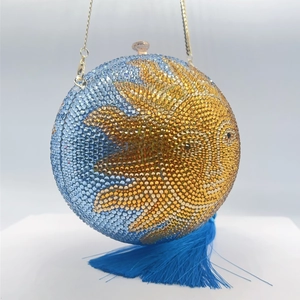 Spherical gold and blue rhinestone clutch bag with sun pattern and blue silk tassel