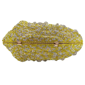 Sparkling conch-shaped lemon clutch bag with yellow and clear rhinestones for gala party