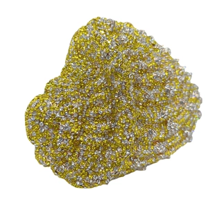 Detailed close-up of a heart-shaped evening clutch with sparkling gold and clear rhinestones
