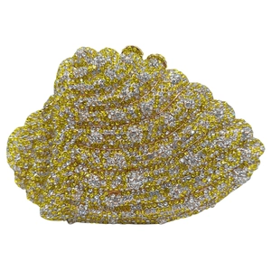 Macro detail of conch-shaped clutch with sparkling yellow and white crystal rhinestones