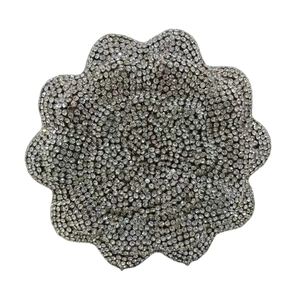 Detail of flower-shaped clutch buckle featuring intricate silver crystal rhinestones