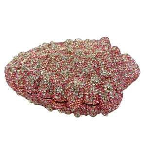 Detail view of wave-patterned pink and white crystal rhinestones on shell clutch bag
