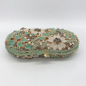 Detailed close-up of floral crystal patterns on a luxury evening clutch purse