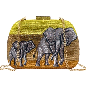 Close-up of sparkling rhinestone elephant clutch bag with golden metal chain strap