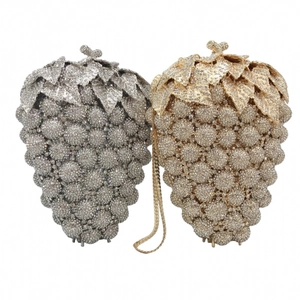 Detailed comparison of gold and silver crystal grape clutch bags with sparkling rhinestones