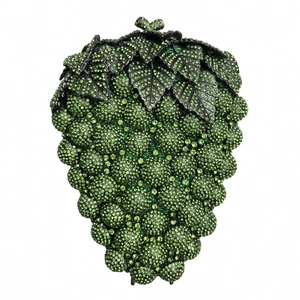Close-up of green rhinestone grape evening clutch bag with intricate metal leaves