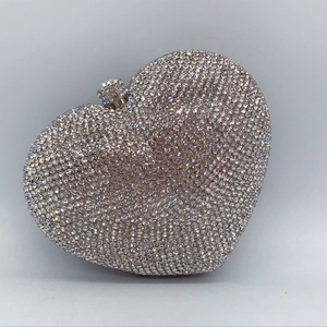 Macro detail of heart-shaped crystal evening clutch bag with luxury silver rhinestones