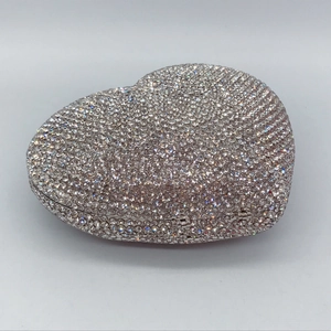 Detailed close-up of heart-shaped crystal clutch bag with silver rhinestones