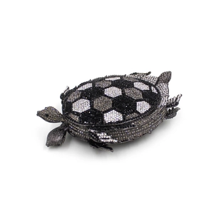 Detail of crystal turtle clutch bag featuring hand-set rhinestones and football pattern