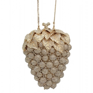 Detail view of the intricate gold grape-shaped evening clutch with sparkling rhinestones
