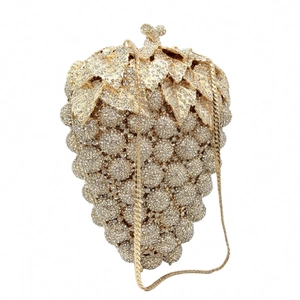 Detail of crystal grape clutch with gold metal leaf and sparkling rhinestone texture