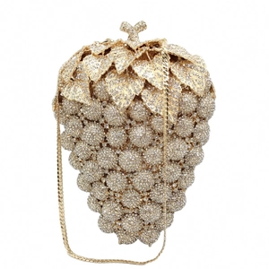 Exquisite detail of grape-shaped evening bag with sparkling rhinestones and golden leaf