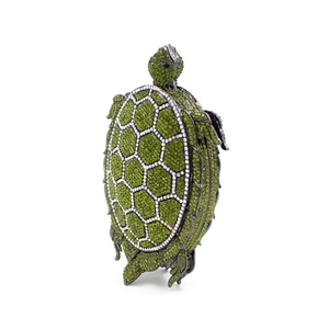 Detail of crystal turtle clutch bag with green rhinestones and silver tortoise shell pattern
