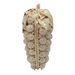 Exquisite close-up of crystal grape-shaped clutch featuring luxury leaf and vine metalwork