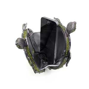 Detailed interior of the green turtle crystal clutch showing smartphone storage space