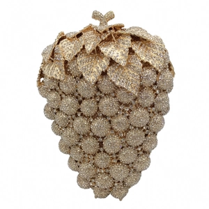 Close-up of golden leaf clasp and crystal-encrusted grape-shaped evening clutch bag