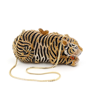 Close-up of tiger clutch bag with detailed gold and black rhinestone embellishments