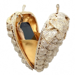 Detailed interior of grape-shaped crystal evening bag showing gold lining and phone storage