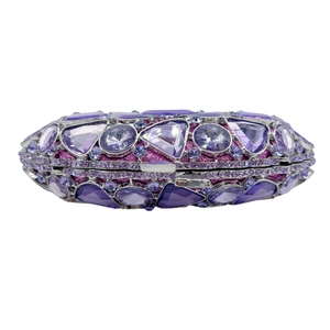 Detailed close-up of luxurious purple crystal evening clutch with silver metal frame