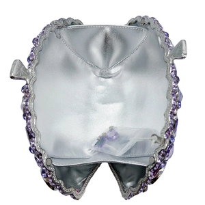 Silver luxury evening clutch bag with purple rhinestones shown in an open view