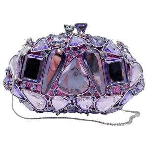 Macro detail of luxury purple crystal clutch with diverse gemstones and silver chain