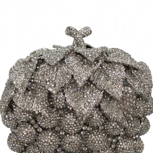 Detailed view of silver crystal grape evening bag with shimmering rhinestone leaf clasp