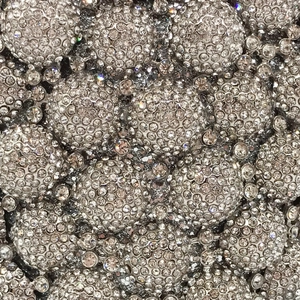 Detailed macro view of high-density silver rhinestones on a luxury evening clutch bag