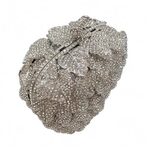Detail of silver leaf-shaped evening clutch with crystal rhinestones and metal clasp