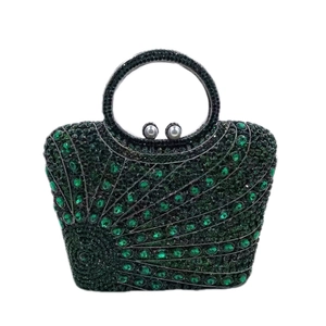 Macro detail of luxury evening clutch with green peacock rhinestone pattern and pearl clasp