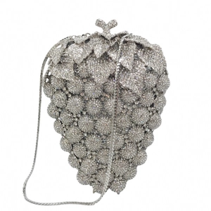 Close-up of luxury grape-shaped evening clutch with silver rhinestones and metal chain