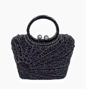 Detail of black rhinestone evening clutch with radial pattern and pearl clasp
