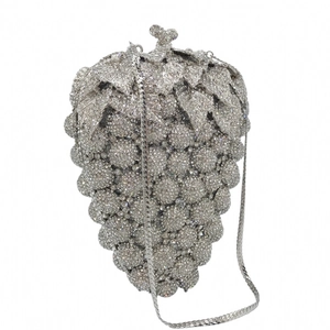 Detail of crystal grape clutch bag with silver rhinestones and leaf-shaped metal handle