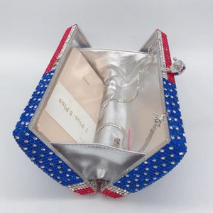 Detail of opened rhinestone clutch showing silver lining and fit for large smartphones
