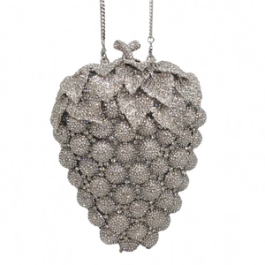 Detail of silver grape-shaped evening clutch bag with sparkling rhinestones and leaf clasp