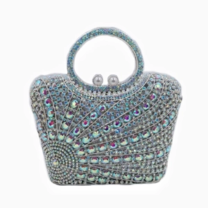 Detail of evening clutch bag with sparkling rhinestones, pearl clasp, and beaded handle