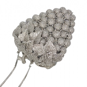 Detailed view of silver crystal grape clutch bag with intricate rhinestones and chain strap