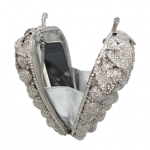 Detail of silver grape-shaped crystal clutch with rhinestone surface and chain strap