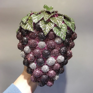 Close-up of luxury grape-shaped evening bag with purple and green crystal rhinestones