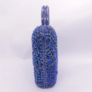 Side view of luxury clutch bag featuring dark blue rhinestones and crystal handle