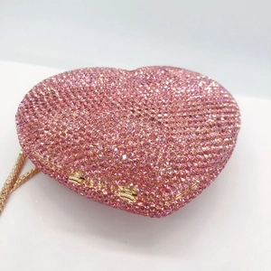 Pink heart-shaped crystal clutch bag with gold metal frame and detachable chain strap