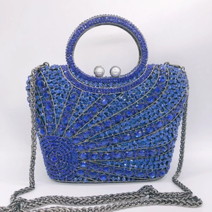 Detail of blue rhinestone clutch showing round crystals and pearl clasp closure