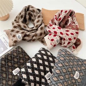 Vue à plat de grosses écharpes en tricot avec motifs à carreaux et étiquettes en tissu