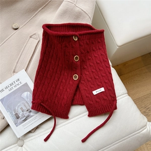 Close-up of deep red knitted collar with cable stitch pattern and wooden buttons