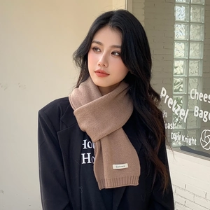 Thick camel knitted cashmere scarf for women styled in a minimalist winter fashion look